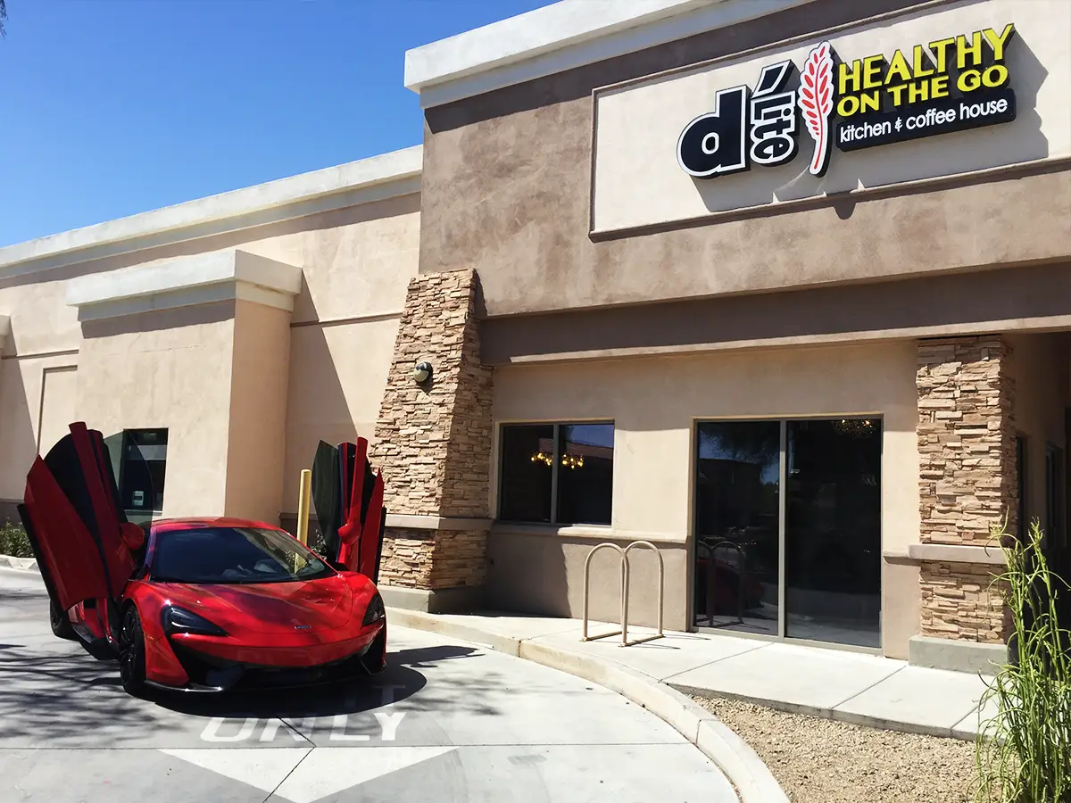 Shea Exterior Drive Thru of D'Lite Healthy on the Go with a nice car out front.